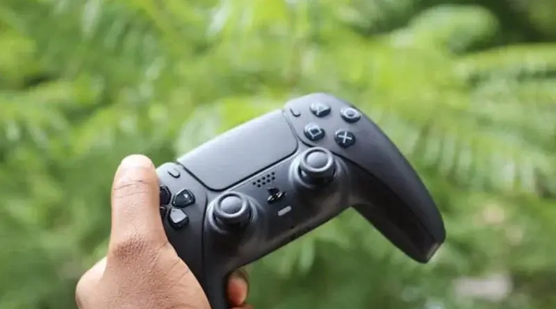 a hand holding a video game controller